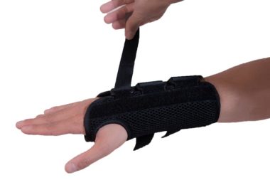 Strapping on Wrist Brace